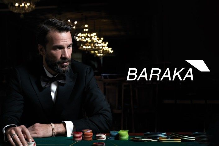 Modelo com fato formal com pulseira Barak da COleo Tocco, em ambiente escuro de casino